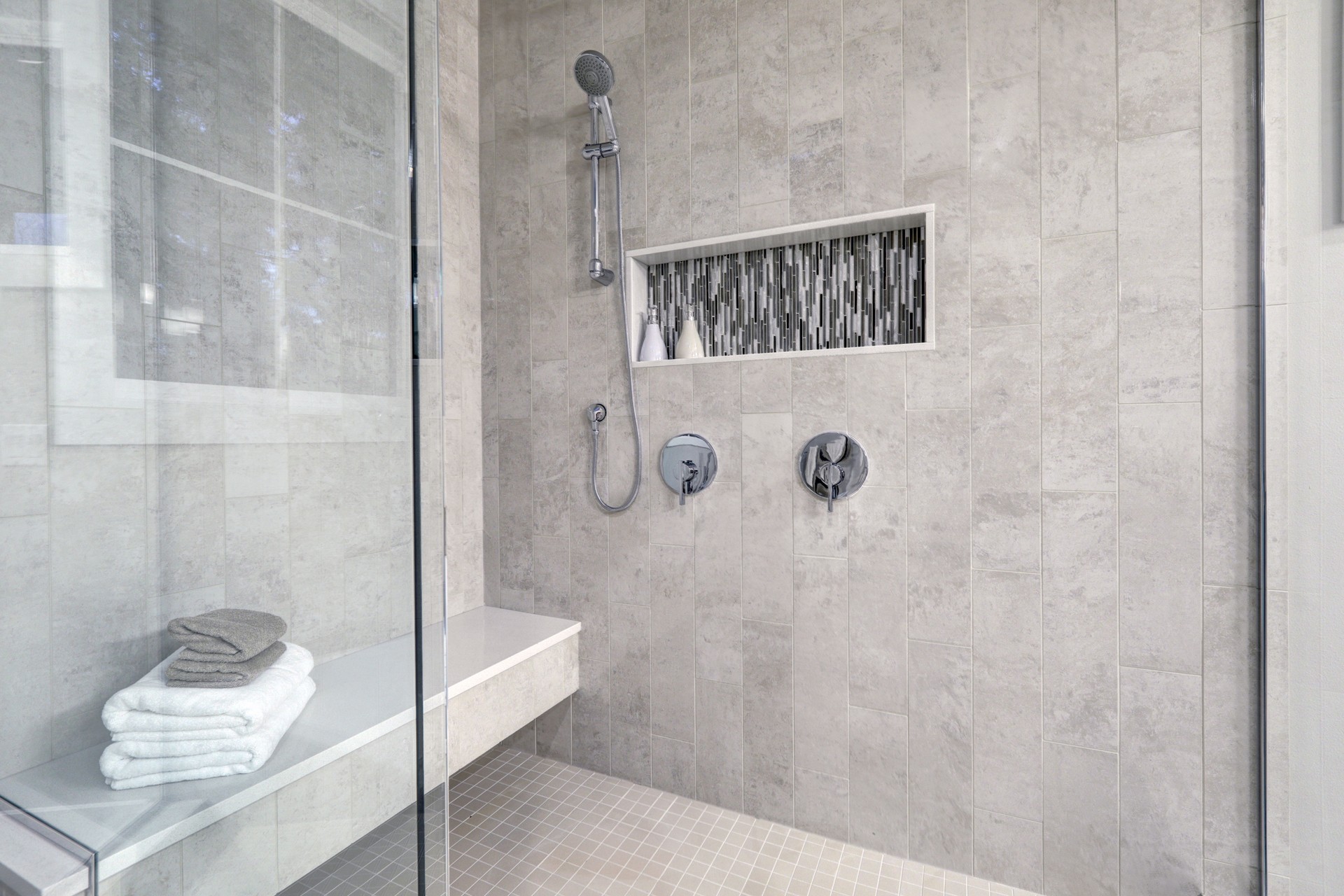 Glass walk-in shower in a bathroom of brand new home
